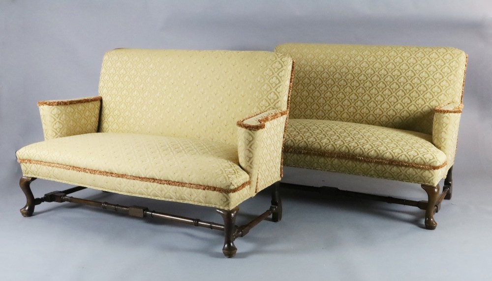 A Queen Anne upholstered scroll arm sofa and a matching reproduction sofa, with cabriole legs, turned stretchers and pad feet, W.5ft H.